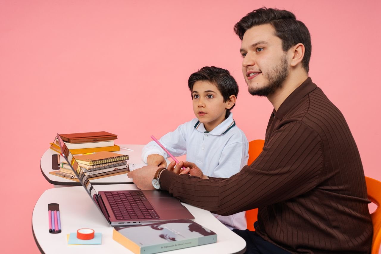 Male teacher and young boy studying together at a desk in Yalova, Türkiye.